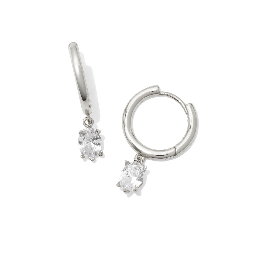 Silver hoop earrings with clear gemstones on a white background