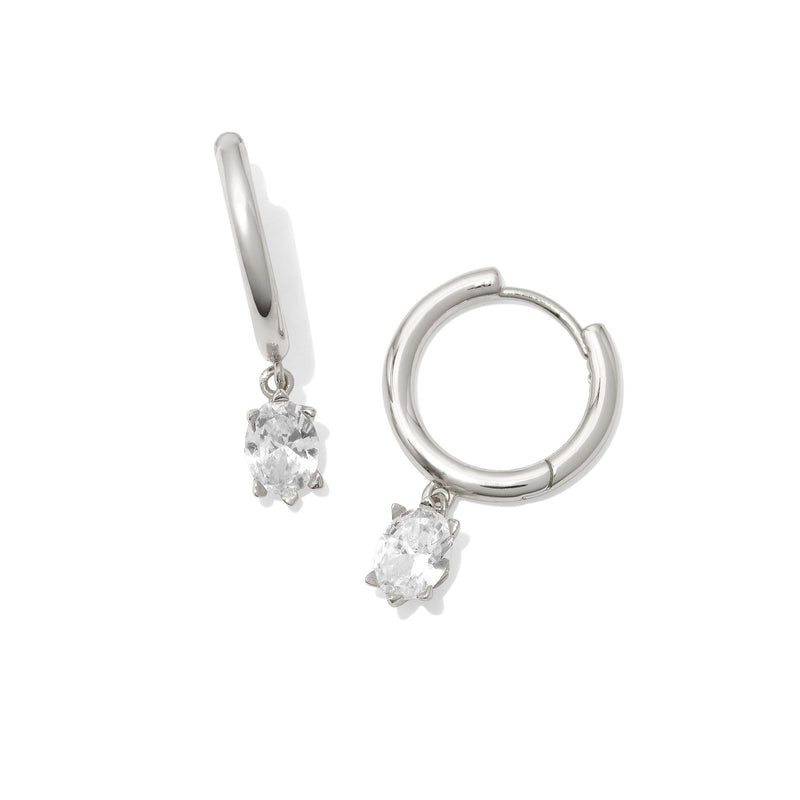 Silver hoop earrings with clear gemstones on a white background