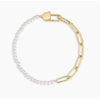 Gold and pearl bracelet on a white background