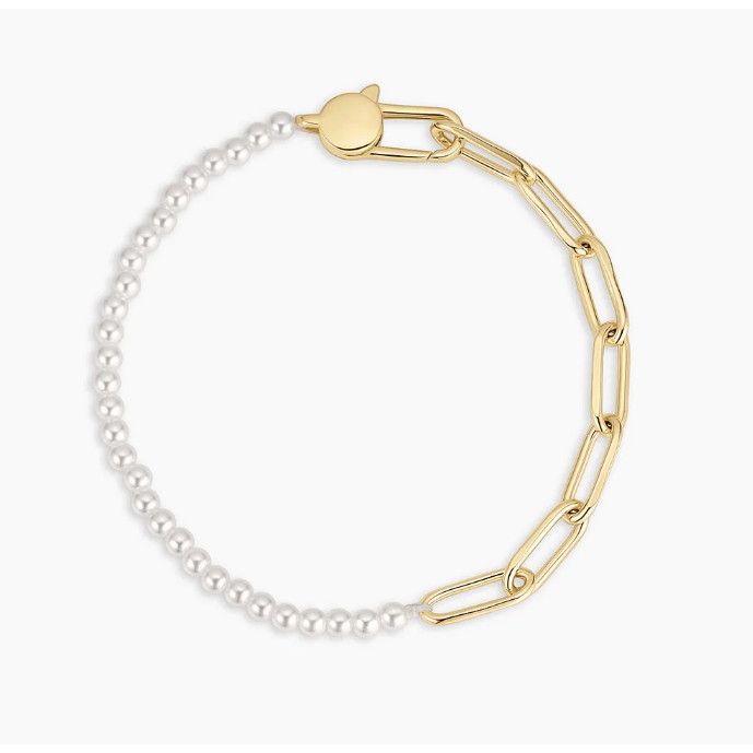 Gold and pearl bracelet on a white background