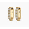 Gold huggie earrings with diamond accents on front.