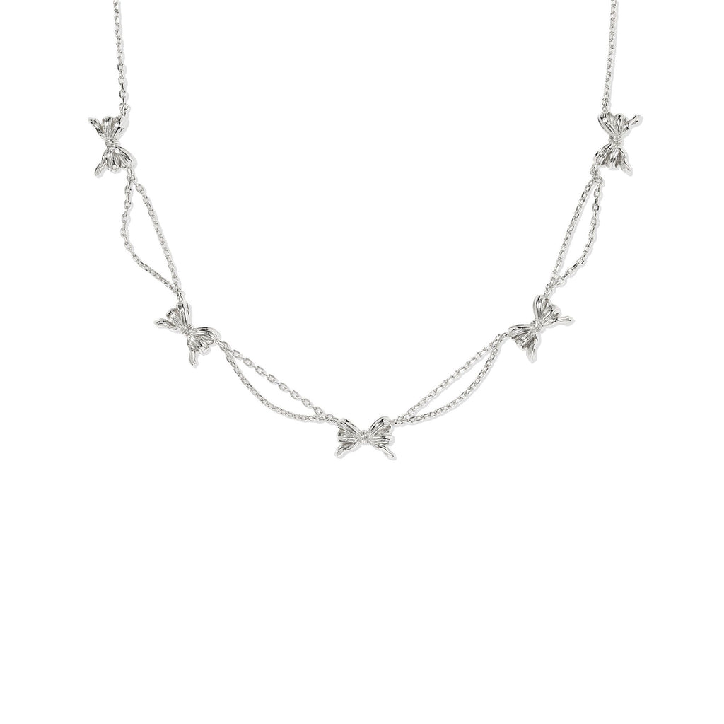 Silver necklace with bow-shaped pendants on a white background
