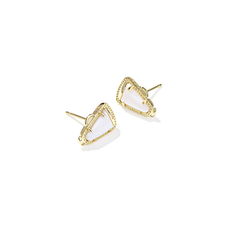 Gold and white earrings on a white background